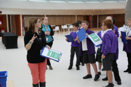 Fran showing a school group around the Curious Nature exhibition