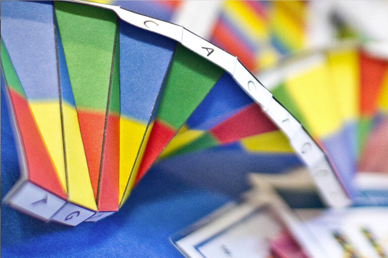Close-up photo of DNA origami activity, colourful paper in a spiral shape