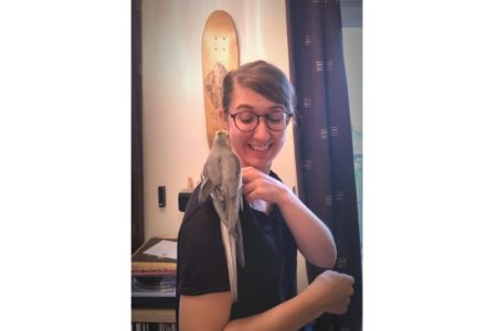 Virginie with Stuart, her cockatiel