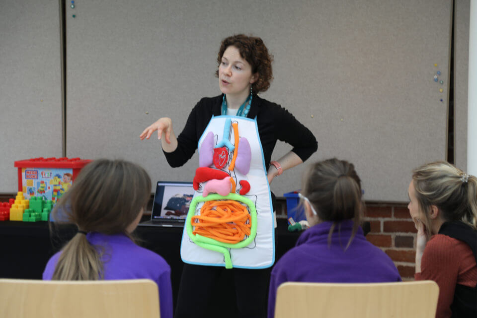 Wellcome Genome Campus researcher talking to school children