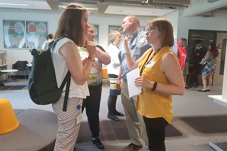 Groups of teachers, talking in pairs