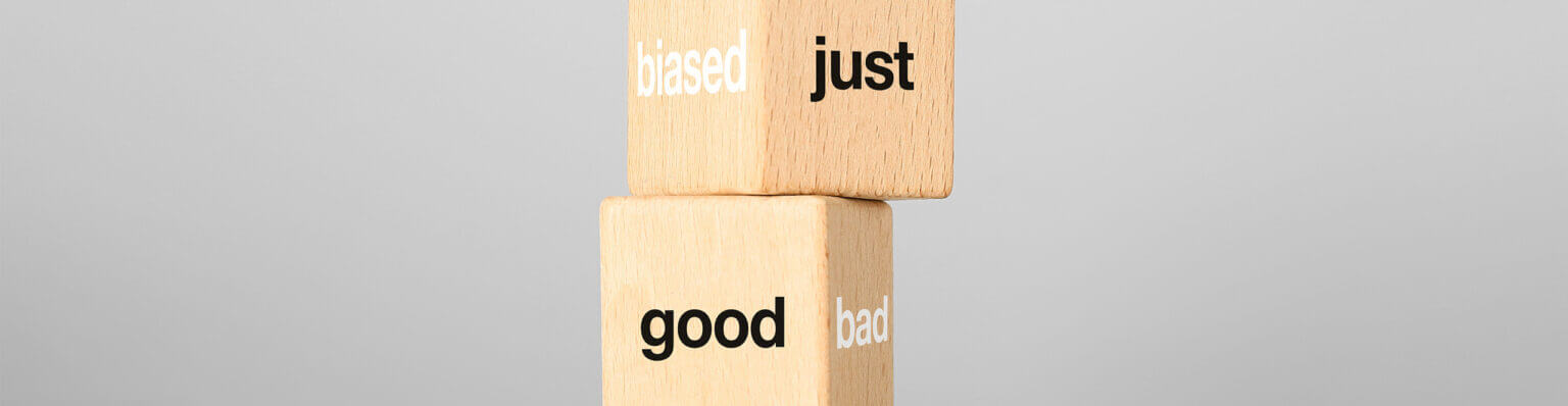 Cross section photograph of a tower of three wooden cubes. Legible: just, good in black; biased, bad in white.