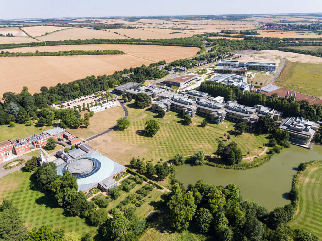 Aerial photo of the Wellcome Genome Campus from 2016, showing Hinxton Hall the the Wellcome Sanger Institute's Sulston building most prominently.